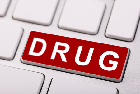 A red button with the word on a white computer keyboard.の写真素材