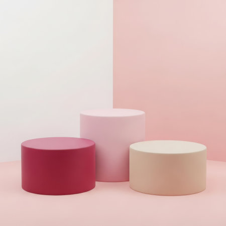 Minimalist pastel colored cylinders on a soft pink backgroundの素材
