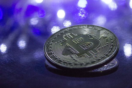 Rio de Janeiro, Brazil - January 16, 2019: Frontal view of golden Bitcoin with bokeh light effect background. Cryptocurrency concept.のeditorial素材
