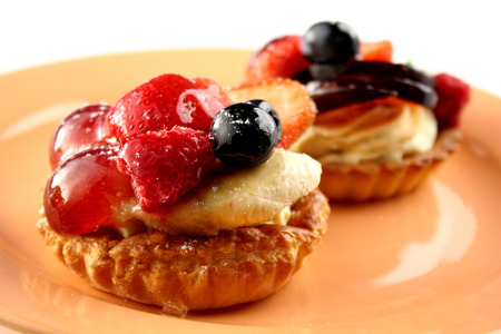 Fruits cakes with butter cream on the plateの写真素材