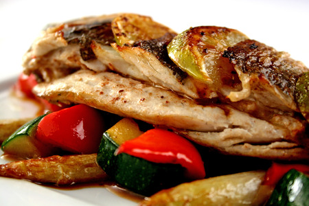 Grilled dorado with slices of lime, sweet pepper, zucchini and the sauce の写真素材