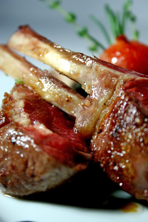 Lamb ribs roast with pureed spinach, tomato, rosemary and balsamic vinegarの写真素材