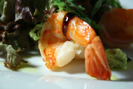 Fried shrimp with salad, olive oil and balsamic on white plateの写真素材