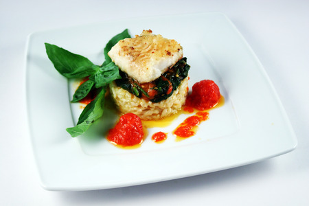 Fish fillet with spinach, tomatoes and riceの写真素材