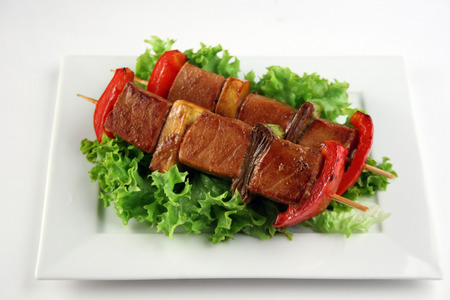 Traditional asian yakitori with pork, sweet pepper, leek and saladの写真素材
