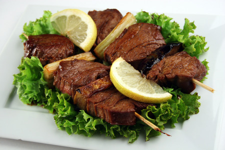 Traditional asian yakitori with beef, eggplant, leek, lemon and saladの写真素材