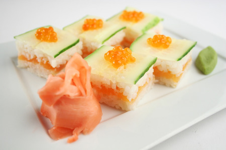 Sushi with salmon, cucumber and red caviar on white plateの写真素材