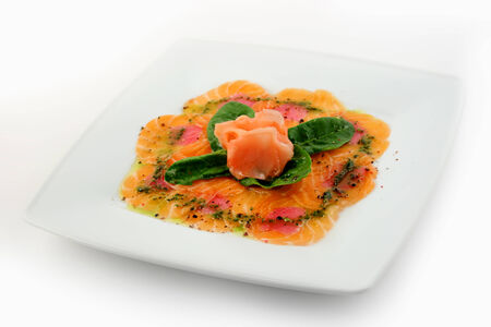 Salmon and tuna carpaccio on white plateの写真素材