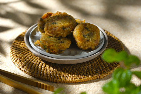 Perkedel kentang or fried mashed potato on plate with brown background