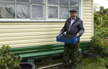 A man with a basket of grapes.の写真素材