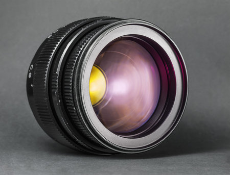 Vintage lens, flare on glas. Old, photo photo camera with scratches on dark background.