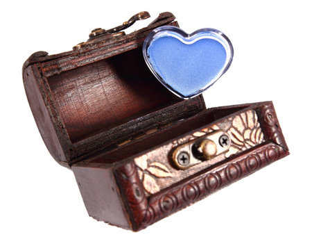 In this photo there is a makeup heart into a wood trunk all in a white background.