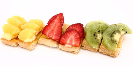 Fruit dessert with puff pastry, cream, kiwi, pineapple and strawberriesの写真素材
