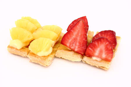 Fruit dessert with puff pastry, cream, pineapple and strawberriesの写真素材