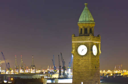 View of the Docks of Hamburg in the evening around the clock tower of the old Elbtunnel in the port facilitiesの写真素材