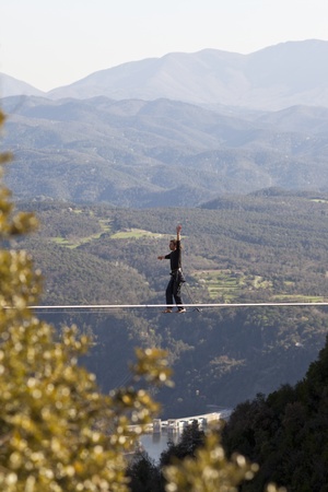 TAVERTET - APRIL 13: Man practicing highline in Tavertet, Spain on April 13, 2013. Highline is a...
