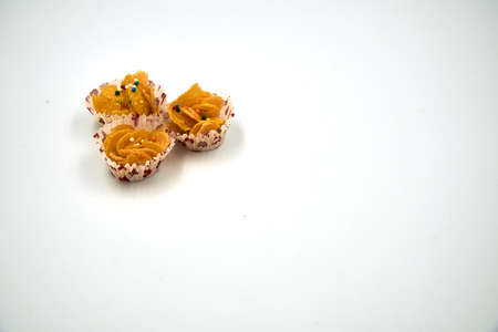 Three honey cornflakes in a paper cup over white backgroundの写真素材