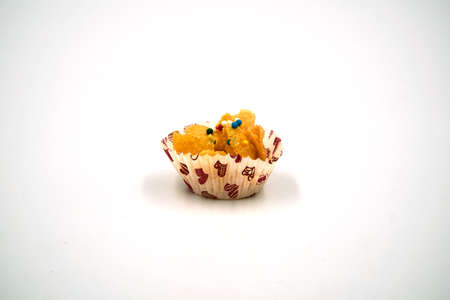 Single honey cornflakes in a paper cup over white backgroundの写真素材