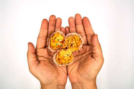 Three honey cornflakes on top of the hand over white backgroundの写真素材