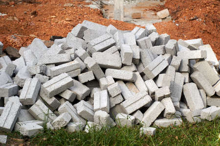 Group of white industrial brick for construction on green grassの写真素材