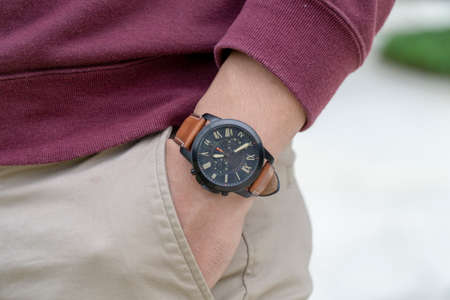 Unidentified asian man wearing black watch with brown leather strapの写真素材