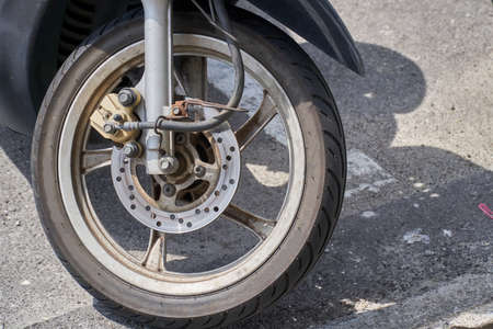 Close up of wheel of a black motorcycle with brake and tyreの写真素材