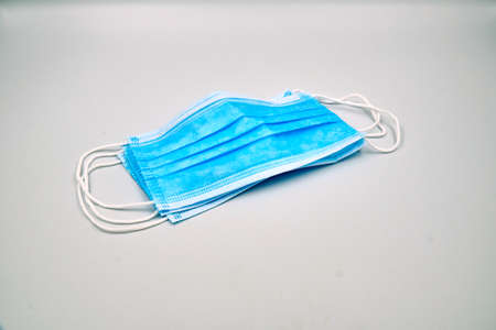 Three blue surgical face mask over grey backgroundの写真素材