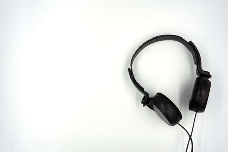 Top view of black color headphone over white backgroundの写真素材