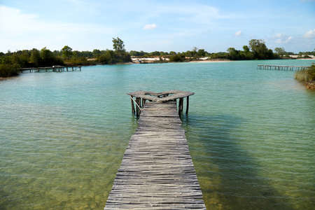 Wide angle view of a wooden bridge at the blue lake, Bintan Island, Batamの写真素材