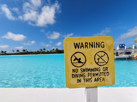 Yellow colored warning no swimming or diving permitted in this area signboardのeditorial素材