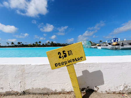 Yellow coloured signboard warning about 2.5 meter deep water levelのeditorial素材