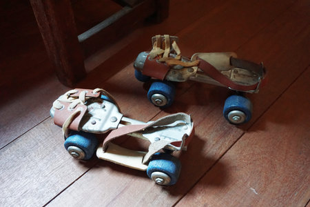 Top view of a pair of old roller skate on the wooden floor