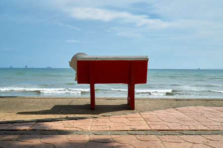 Close up view of red bench facing towards Ao Nang beach, Krabiの写真素材