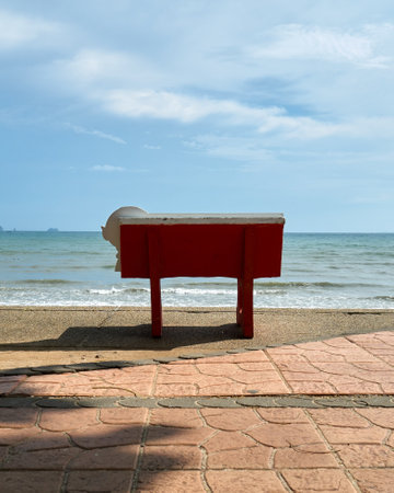 Close up view of red bench facing towards Ao Nang beach, Krabiの写真素材