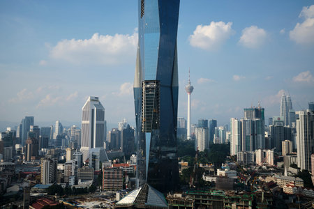 View of Merdeka PNB118 in construction with other skyscrapers in Kuala Lumpur during the dayのeditorial素材