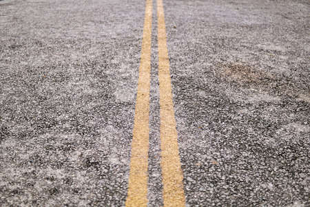 Close up of asphalt road with double yellow lines in the middleの写真素材