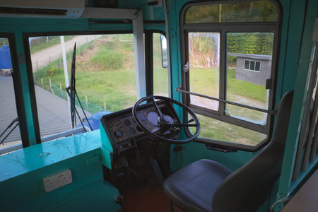 Interior of an old bus focusing on the driver seatの写真素材