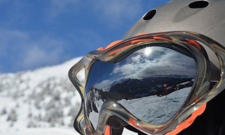 alpine winter landscape with a ski slope is reflected in a ski maskの写真素材