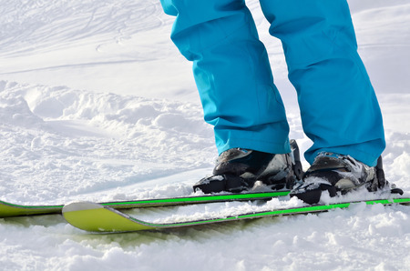 woman s legs in ski boots, standing on alpine skisの写真素材