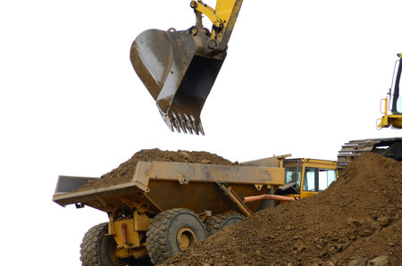 Large track hoe loading an articulated large dump truck at a new road project in Oregon
