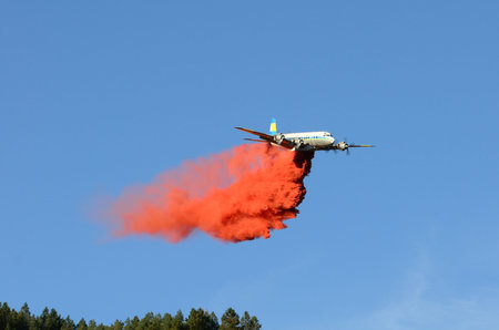 Large air tanker droping fire retardant at a working  natural cover fire near Roseburg Oregon