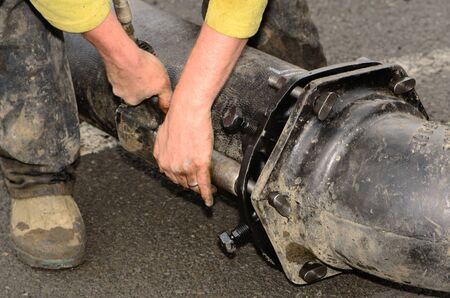Workers connecting a large water pipe together during a new commercial development projectの写真素材