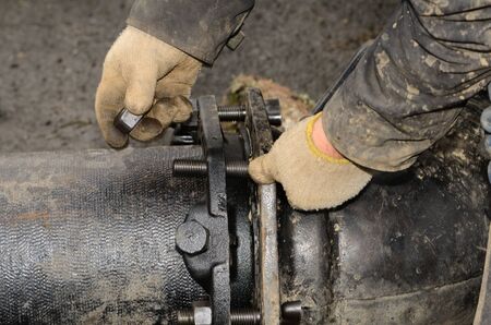 Workers connecting a large water pipe together during a new commercial development projectの写真素材