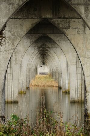The arch structure of a large State Hwy 101 bridge crossing the Umpqua River near Reedsport on the Oregon Coastの写真素材