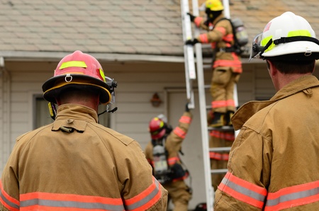 Roseburg, OR USA - July 21, 2011: Roseburg Fire command staff participating in a ventilation drill at a old hotel.のeditorial素材