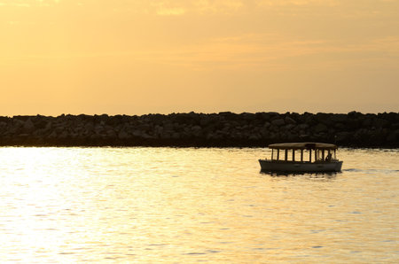 Sunset and canopy boat at Newport Beach in the southwest part of Los Angeles CA