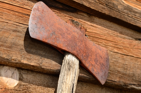 Old double headed loging axe on a wood cabin wallの写真素材