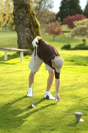 A amature golfer competes on a 18 hole golf courseの写真素材