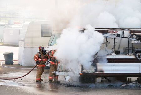 Well involved fire in a travel trailer being used as a residence in a trailer park, Fire fighters attacking the fire.. Roseburg, Oregon, April 4th 2008のeditorial素材
