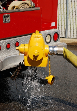 Testing fire hydrants using a new hydrant diffuser that was made by Roseburg City Public Works for the fire dept   It uses the top of a old waterous hydrant top that is welded to a trailer hitch stinger のeditorial素材